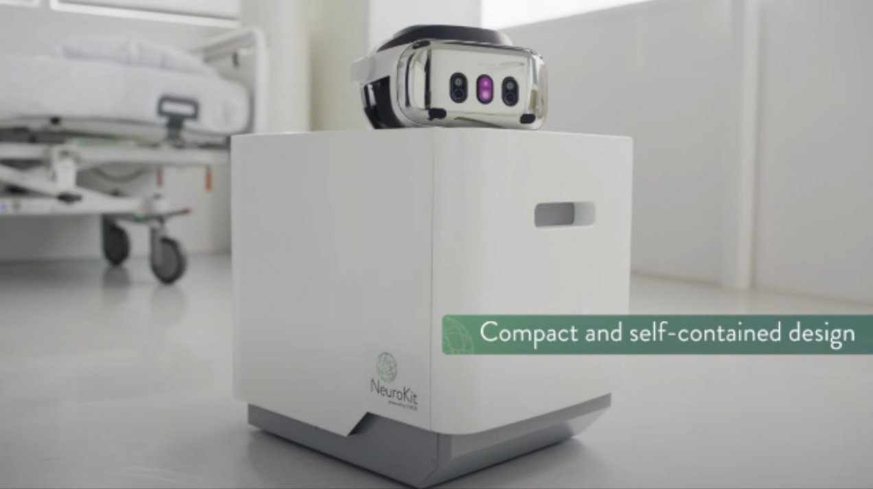 The NeuroKit, a compact white unit with a Varjo XR-4 headset resting on top, in a clinical room